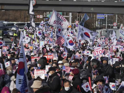 Supporters of impeached South Korean President Yoon Suk Yeol stage a rally to oppose a court having issued a warrant to detain Yoon, near the presidential residence in Seoul, South Korea, Friday, Jan. 3, 2025. The letters read, "Oppose Impeachment." (AP Photo/Lee Jin-man)