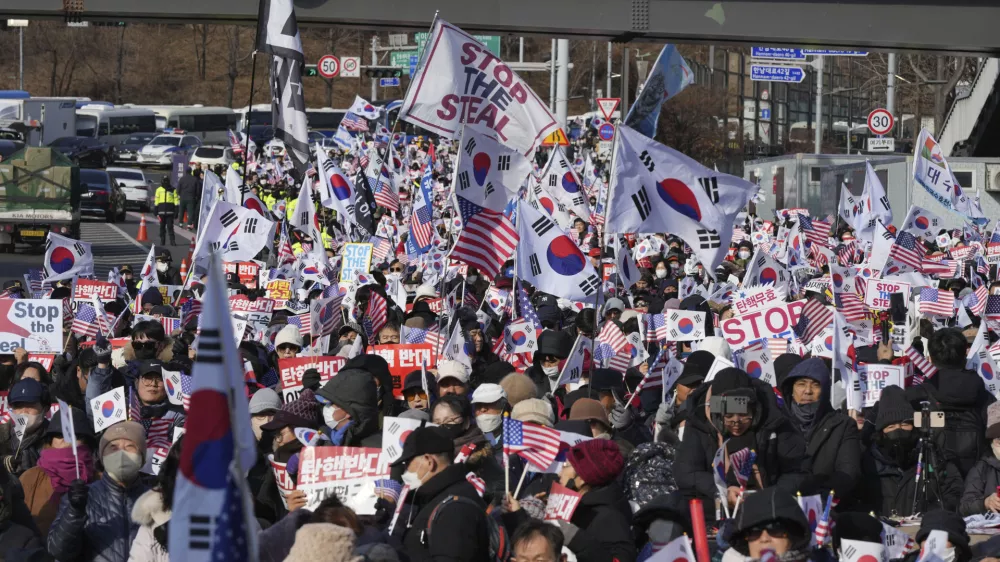 Supporters of impeached South Korean President Yoon Suk Yeol stage a rally to oppose a court having issued a warrant to detain Yoon, near the presidential residence in Seoul, South Korea, Friday, Jan. 3, 2025. The letters read, "Oppose Impeachment." (AP Photo/Lee Jin-man)