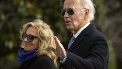 President Joe Biden gestures as he and first lady Jill Biden walk across the South Lawn of the White House, Thursday, Jan. 2, 2025, in Washington, after returning from Camp David. (AP Photo/Mark Schiefelbein)