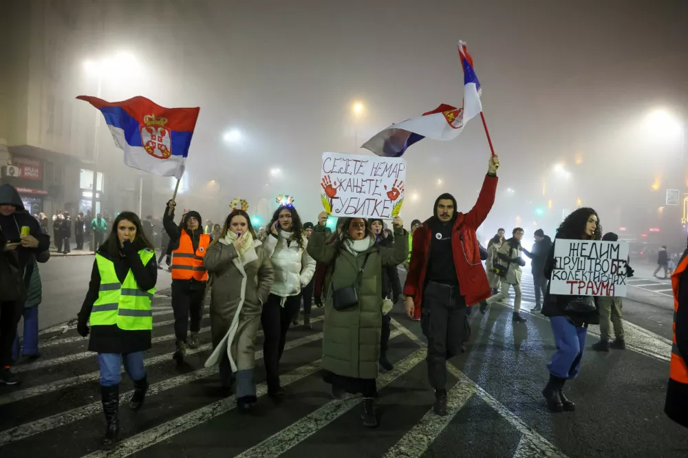 Students hold banners and chant slogans during a a New Year's Eve protest under the slogan 'There is no New Year - you still owe us for last one' organised against government policies and corruption, which they blame for the deaths of the victims in the Novi Sad railway station disaster in November, in Belgrade, Serbia, December 31, 2024. REUTERS/Djordje Kojadinovic