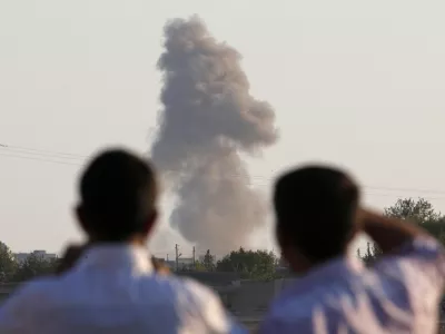 ﻿Turkish Kurds standing on the outskirts of Suruc, on the Turkey-Syria border, watch smoke rise following an airstrike in Kobani, Syria, where the fighting between militants of the Islamic State group and Kurdish forces intensified, Tuesday, Oct. 7, 2014. Kobani, also known as Ayn Arab and its surrounding areas have been under attack since mid-September, with militants capturing dozens of nearby Kurdish villages. (AP Photo/Lefteris Pitarakis)