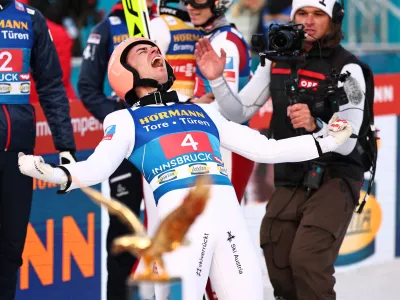 04 January 2025, Austria, Innsbruck: Austria's Stefan Kraft (R) celebrates victory after the men's Large Hill Tournament at the FIS Ski Jumping World Cup. Photo: Daniel Karmann/dpa