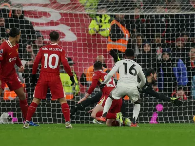 Soccer Football - Premier League - Liverpool v Manchester United - Anfield, Liverpool, Britain - January 5, 2025 Manchester United's Amad Diallo scores their second goal past Liverpool's Alisson Becker REUTERS/Phil Noble EDITORIAL USE ONLY. NO USE WITH UNAUTHORIZED AUDIO, VIDEO, DATA, FIXTURE LISTS, CLUB/LEAGUE LOGOS OR 'LIVE' SERVICES. ONLINE IN-MATCH USE LIMITED TO 120 IMAGES, NO VIDEO EMULATION. NO USE IN BETTING, GAMES OR SINGLE CLUB/LEAGUE/PLAYER PUBLICATIONS. PLEASE CONTACT YOUR ACCOUNT REPRESENTATIVE FOR FURTHER DETAILS..