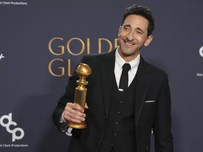 Adrien Brody poses in the press room with the award for best performance by a male actor in a motion picture - drama for "The Brutalist" during the 82nd Golden Globes on Sunday, Jan. 5, 2025, at the Beverly Hilton in Beverly Hills, Calif. (AP Photo/Chris Pizzello)