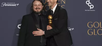 Brady Corbet, winner of the award for best director - motion picture for "The Brutalist", left, Adrien Brody, winner of the award for best performance by a male actor in a motion picture - drama for "The Brutalist", pose in the press room during the 82nd Golden Globes on Sunday, Jan. 5, 2025, at the Beverly Hilton in Beverly Hills, Calif. (AP Photo/Chris Pizzello)