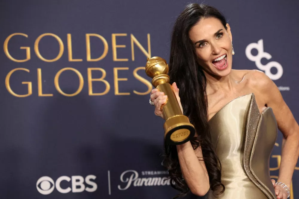 FILE PHOTO: Demi Moore poses with the award for Best Performance by an Actress in a Motion Picture - Musical or Comedy, for The Substance, at the 82nd Golden Globe Awards in Beverly Hills, California, U.S., January 5, 2025. REUTERS/Mario Anzuoni/File Photo