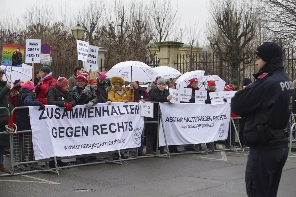 Members of the group "Grannies against the right" attend a protest outside the presidential office, in Vienna, Austria, Monday, Jan. 06, 2025. (AP Photo/Heinz-Peter Bader)