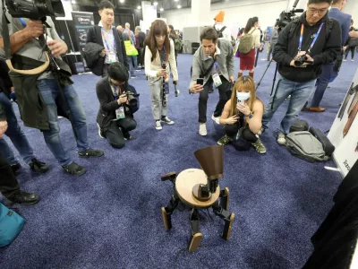 People look at the Mi-Mo AI robot during CES Unveiled at CES 2025, an annual consumer electronics trade show, in Las Vegas, Nevada, U.S. January 5, 2025. REUTERS/Steve Marcus