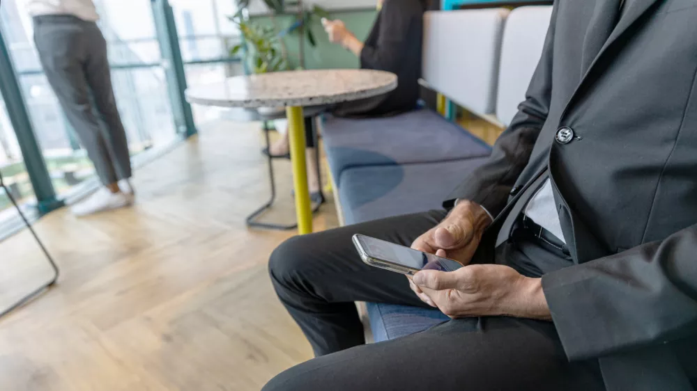 Hand of a manager is using tablet drafting his business plan on a table. Young office worker applies digital tool and application for his startup business to save cost and make resource efficient