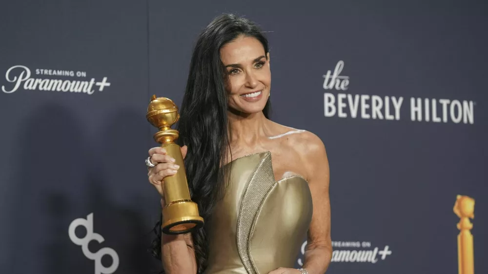 Demi Moore poses in the press room with the award for best performance by a female actor in a motion picture - musical or comedy for "The Substance" during the 82nd Golden Globes on Sunday, Jan. 5, 2025, at the Beverly Hilton in Beverly Hills, Calif. (AP Photo/Chris Pizzello)