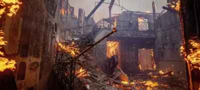 The Palisades Fire burns a residence in the Pacific Palisades neighborhood of Los Angeles, Tuesday, Jan. 7, 2025. (AP Photo/Ethan Swope)