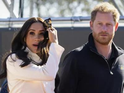 FILE - Prince Harry and Meghan Markle, Duke and Duchess of Sussex visit the track and field event at the Invictus Games in The Hague, Netherlands, Sunday, April 17, 2022. Prince Harry and his wife, Meghan, are expected to vent their grievances against the monarchy when Netflix releases the final episodes of a series about the couple's decision to step away from royal duties and make a new start in America. (AP Photo/Peter Dejong, File)