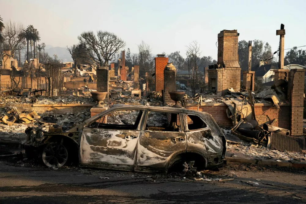 The remains of a car following the Palisades Fire in the Pacific Palisades neighborhood in Los Angeles, California, U.S. January 10, 2025. REUTERS/David Ryder