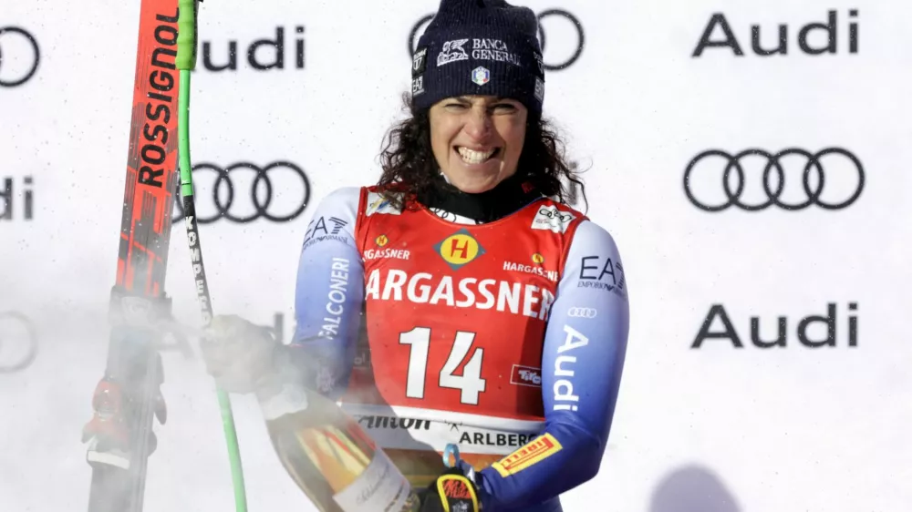 Alpine Skiing - FIS Alpine Ski World Cup - Women's Downhill - St. Anton, Austria - January 11, 2025 Italy's Federica Brignone celebrates on the podium after winning the Women's Downhill REUTERS/Leonhard Foeger