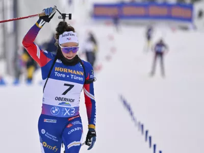 Lou Jeanmonnot from France celebrates winning the women's Biathlon World Cup 10 km pursuit in Oberhof, Germany, Saturday Jan. 11, 2025. (Martin Schutt/dpa via AP)