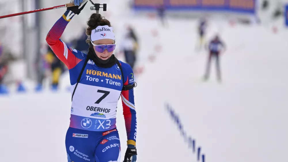 Lou Jeanmonnot from France celebrates winning the women's Biathlon World Cup 10 km pursuit in Oberhof, Germany, Saturday Jan. 11, 2025. (Martin Schutt/dpa via AP)