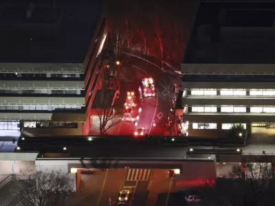 First responders work the scene of a hummer attack at Hosei University's Tama campus in Machida, a suburb of Tokyo, Friday, Jan. 10, 2025. (Kyodo News via AP)