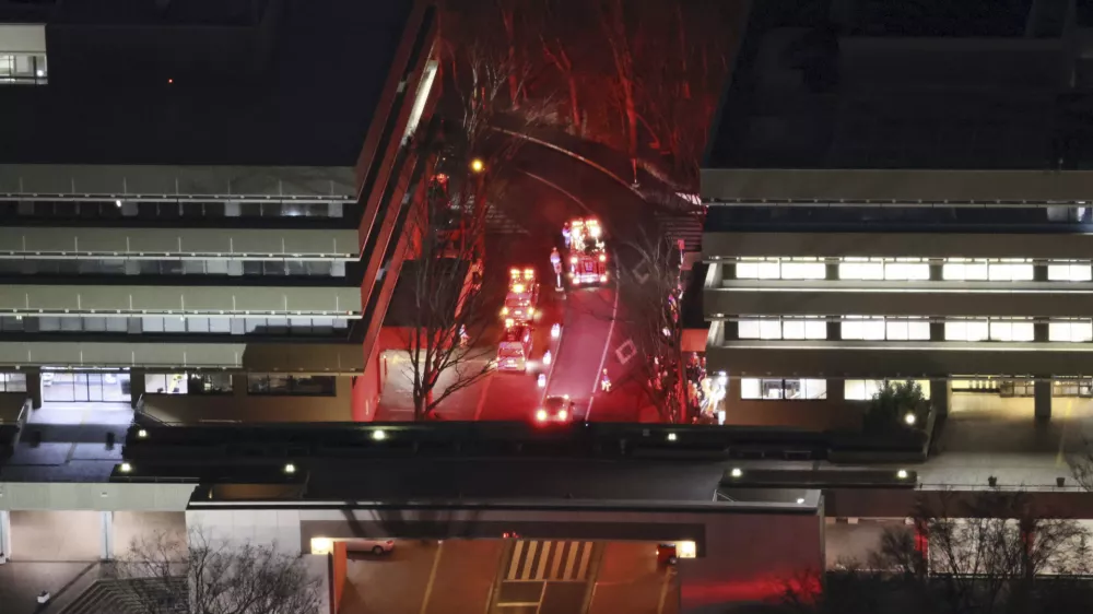 First responders work the scene of a hummer attack at Hosei University's Tama campus in Machida, a suburb of Tokyo, Friday, Jan. 10, 2025. (Kyodo News via AP)