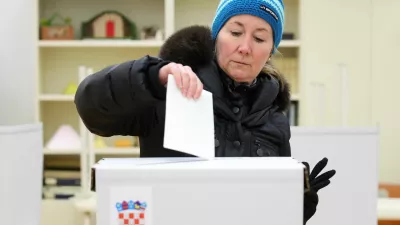 A woman votes at a polling station during the second round of the presidential election in Zagreb, Croatia, January 12, 2025. REUTERS/Antonio Bronic