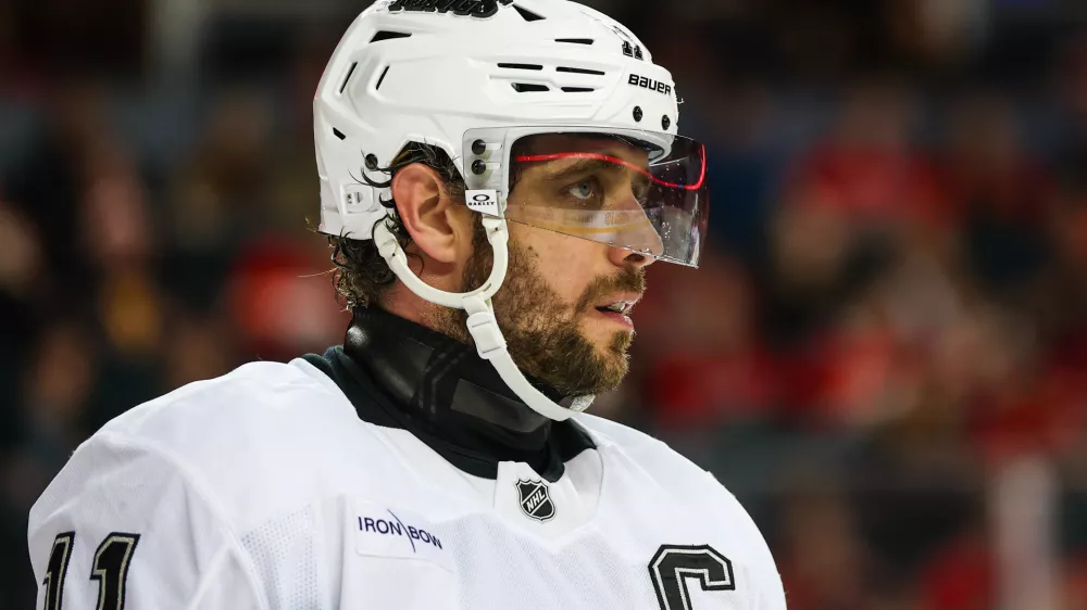 Jan 11, 2025; Calgary, Alberta, CAN; Los Angeles Kings center Anze Kopitar (11) during the face off against the Calgary Flames during the third period at Scotiabank Saddledome. Mandatory Credit: Sergei Belski-Imagn Images