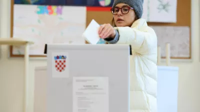 A woman votes at a polling station during the second round of the presidential election in Zagreb, Croatia, January 12, 2025. REUTERS/Antonio Bronic