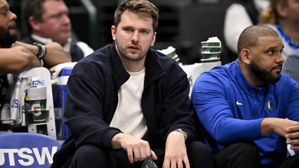 Jan 12, 2025; Dallas, Texas, USA; Dallas Mavericks guard Luka Doncic (77) reacts from the team bench during the second half of the game against the Denver Nuggets at the American Airlines Center. Mandatory Credit: Jerome Miron-Imagn Images