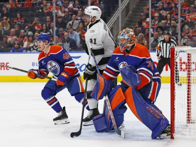 Jan 13, 2025; Edmonton, Alberta, CAN; Los Angeles Kings forward Anze Kopitar (11) looks for a loose puck in front of Edmonton Oilers goaltender Stuart Skinner (74) during the second period at Rogers Place. Mandatory Credit: Perry Nelson-Imagn Images