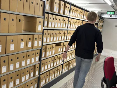 An archivist walks by file cabinets where documents, some regarding WWII collaboration, are stored at the NIOD Institute for War, Holocaust and Genocide Studies in Amsterdam, Netherlands, Friday, Jan. 10, 2025. (AP Photo/Aleks Furtula)