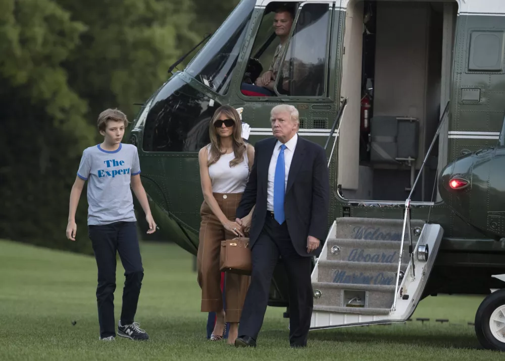 ﻿President Donald Trump, first lady Melania Trump, and their son, Barron Trump, walk from Marine One across the South Lawn to the White House in Washington, Sunday, June 11, 2017, as they returned from Bedminster, N.J. (AP Photo/Carolyn Kaster)