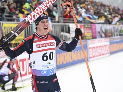 Vebjoern Soerum from Norway cheers at the finish after the men's individual 20km at the Biathlon World Cup in Ruhpolding, Germany, Wednesday Jan. 15, 2025. (Sven Hoppe/dpa via AP)