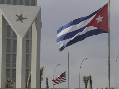 Cuban and American flags fly in the wind outside the American embassy in Havana, Cuba, Tuesday, Jan.14, 2025. (AP Photo/Ariel Ley)