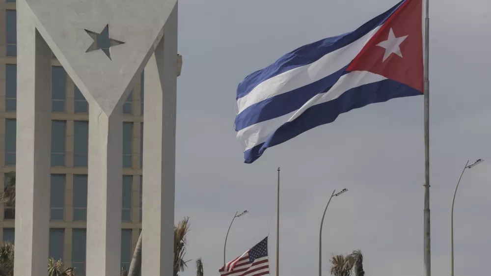 Cuban and American flags fly in the wind outside the American embassy in Havana, Cuba, Tuesday, Jan.14, 2025. (AP Photo/Ariel Ley)