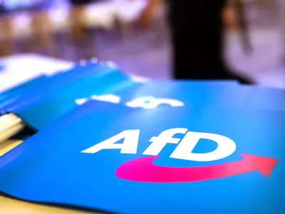 FILED - 24 November 2018, Bavaria, Greding: The far-right Alternative for Germany (AfD) flag placed on a table. The AfD party sent "deportation tickets" for "illegal immigrants" to mailboxes around the city of Karlsruhe, a local AfD official confirmed to dpa on 14 January. Photo: Daniel Karmann/dpa