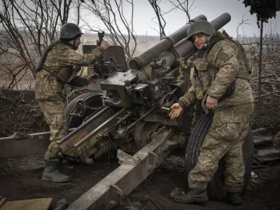 FILE - Ukrainian soldiers of the 71st Jaeger Brigade fire a M101 howitzer towards Russian positions at the frontline, near Avdiivka, Donetsk region, Ukraine, Friday, March 22, 2024. Much of what NATO can do for Ukraine, and indeed for global security, is misunderstood. Often in the public mind, the alliance is thought of as the sum of all U.S. relations with its European partners, from imposing sanctions and other costs on Russia to sending arms and ammunition. But as an organization its brief is limited to the defense by military means of its 32 member countries and a commitment to help keep the peace in Europe and North America. (AP Photo/Efrem Lukatsky, File)