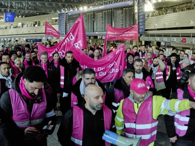 Airport employees organized in the Komba union walk through the airport in Frankfurt, Germany, Monday, March 10, 2025, when all major airports in Germany went on a warning strike. (AP Photo/Michael Probst)