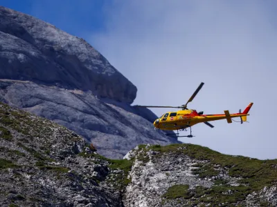 A helicopter participates in a search and rescue operation at the site of a deadly collapse of parts of a mountain glacier in the Italian Alps amid record temperatures, at Marmolada ridge, Italy July 5, 2022. REUTERS/Guglielmo Mangiapane