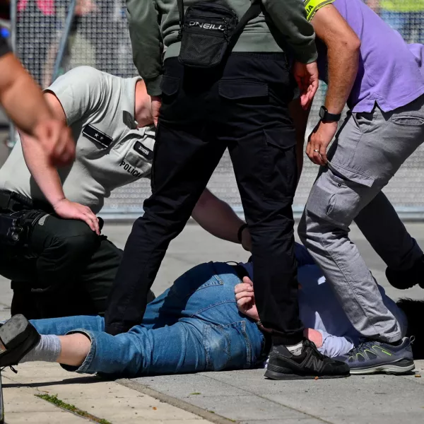 FILE PHOTO: A person is detained after shooting incident of Slovak PM Robert Fico, after a Slovak government meeting in Handlova, Slovakia, May 15, 2024. REUTERS/Radovan Stoklasa/File Photo