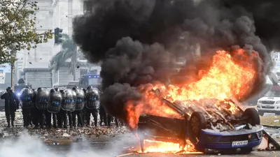 12 June 2024, Argentina, Buenos Aires: A Volkswagen car burns in front of Congress during a protest against the reform plan of President Milei's ultra-liberal government, which is being debated in Congress. Among other things, the plan provides for new regulations for high investments and a more flexible labour market. Photo: Fernando Gens/dpa