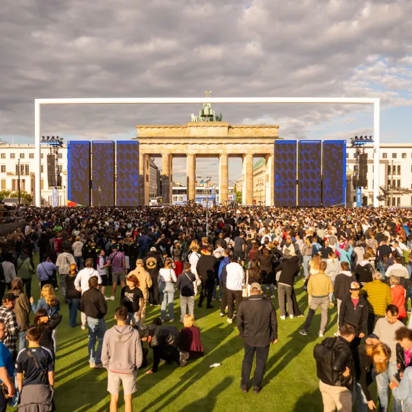 12 June 2024, Berlin: People gather in the fan zone during the UEFA EURO 2024 opening ceremony of the fan mile at the Brandenburg Gate. Photo: Christophe Gateau/dpa