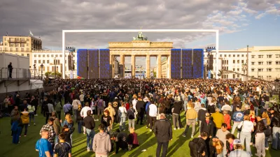 12 June 2024, Berlin: People gather in the fan zone during the UEFA EURO 2024 opening ceremony of the fan mile at the Brandenburg Gate. Photo: Christophe Gateau/dpa