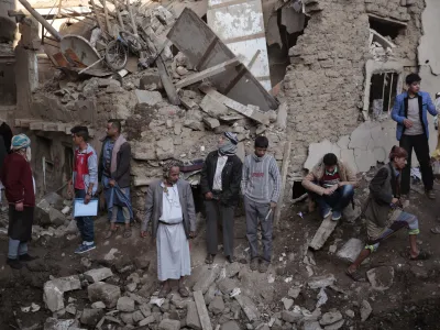 FILE - People gather at the site of a Saudi-led airstrike near Yemen's Defense Ministry complex in Sanaa, Yemen, Saturday, Nov. 11, 2017. The world must not lose sight of the plight of those living through the yearslong war in Yemen, Katharina Ritz, the International Committee of the Red Cross' head of delegation in Yemen said Friday, March 11, 2022, urging continued aid for the Middle East's poorest nation as the war in Ukraine grabs the world's attention. (AP Photo/Hani Mohammed)