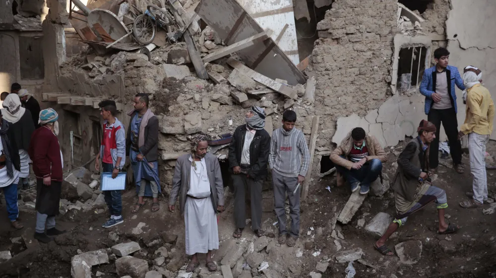 FILE - People gather at the site of a Saudi-led airstrike near Yemen's Defense Ministry complex in Sanaa, Yemen, Saturday, Nov. 11, 2017. The world must not lose sight of the plight of those living through the yearslong war in Yemen, Katharina Ritz, the International Committee of the Red Cross' head of delegation in Yemen said Friday, March 11, 2022, urging continued aid for the Middle East's poorest nation as the war in Ukraine grabs the world's attention. (AP Photo/Hani Mohammed)