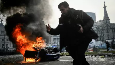 A car burns during a protest near the National Congress, on the day Senators debate Argentina's President Javier Milei's economic reform bill, known as the "omnibus bill", in Buenos Aires, Argentina, June 12, 2024. REUTERS/Mariana Nedelcu