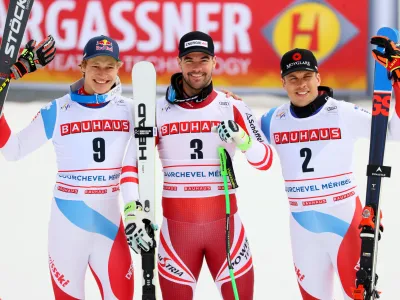 Alpine Skiing - FIS Alpine Ski World Cup - Men's Super G - Courchevel, France - March 17, 2022 Austria's Vincent Kriechmayr celebrates after winning the Men's Super G, alongside second place Switzerland's Marco Odermatt and third place Switzerland's Gino Caviezel REUTERS/Denis Balibouse