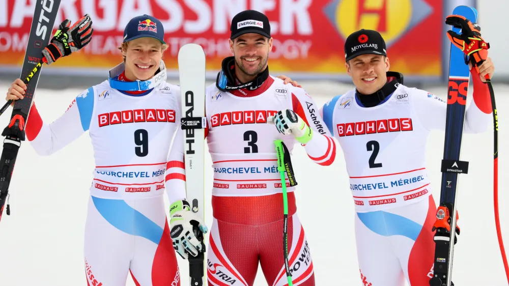 Alpine Skiing - FIS Alpine Ski World Cup - Men's Super G - Courchevel, France - March 17, 2022 Austria's Vincent Kriechmayr celebrates after winning the Men's Super G, alongside second place Switzerland's Marco Odermatt and third place Switzerland's Gino Caviezel REUTERS/Denis Balibouse