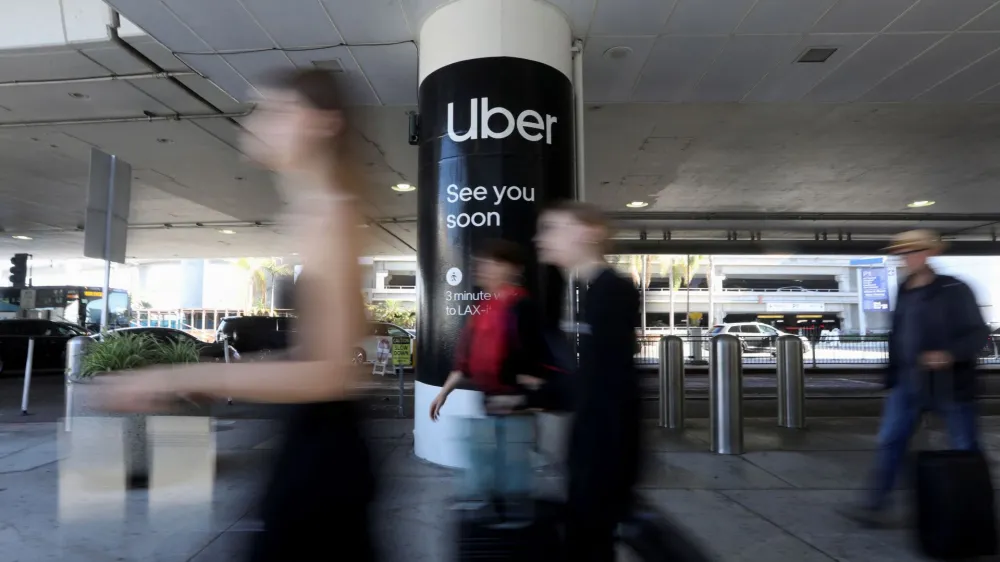 Uber ride-share signage is posted at Los Angeles International Airport (LAX) in Los Angeles, California, U.S. July 10, 2022. REUTERS/David Swanson