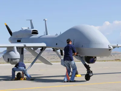 FILE PHOTO: Workers prepare an MQ-1C Gray Eagle unmanned aerial vehicle for static display at Michael Army Airfield, Dugway Proving Ground in Utah in this September 15, 2011 US Army handout photo obtained by Reuters February 6, 2013.  REUTERS/U.S. Army/Spc. Latoya Wiggins/Handout  THIS IMAGE HAS BEEN SUPPLIED BY A THIRD PARTY. IT IS DISTRIBUTED, EXACTLY AS RECEIVED BY REUTERS, AS A SERVICE TO CLIENTS. FOR EDITORIAL USE ONLY. NOT FOR SALE FOR MARKETING OR ADVERTISING CAMPAIGNS/File Photo