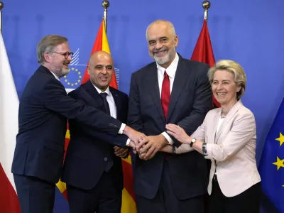 From right, European Commission President Ursula von der Leyen, Albanian Prime Minister Edi Rama, North Macedonia's Prime Minister Dimitar Kovacevski and Czech Republic's Prime Minister Petr Fiala shake hands prior to a meeting at EU headquarters in Brussels, Tuesday, July 19, 2022. The European Union on Tuesday is starting the long enlargement process that aims to lead to the membership of Albania and North Macedonia in the bloc. (AP Photo/Virginia Mayo)