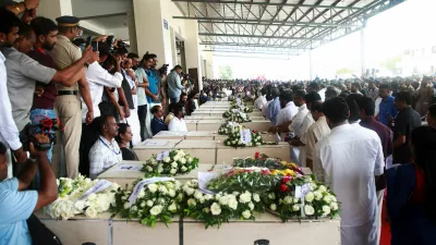 People gather around the coffins containing the bodies of people who died during a fire that broke out in a building housing foreign workers in Kuwait, upon their arrival at Cochin International Airport, in Kochi, in the southern Indian state of Kerala, June 14, 2024. Reuters/Sivaram V