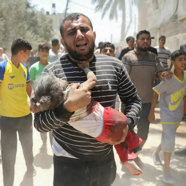 SENSITIVE MATERIAL. THIS IMAGE MAY OFFEND OR DISTURB A Palestinian man carries an injured child following an Israeli strike, amid the Israel-Hamas conflict, in Deir Al-Balah, in the central Gaza Strip, June 14, 2024. REUTERS/Abed Khaled